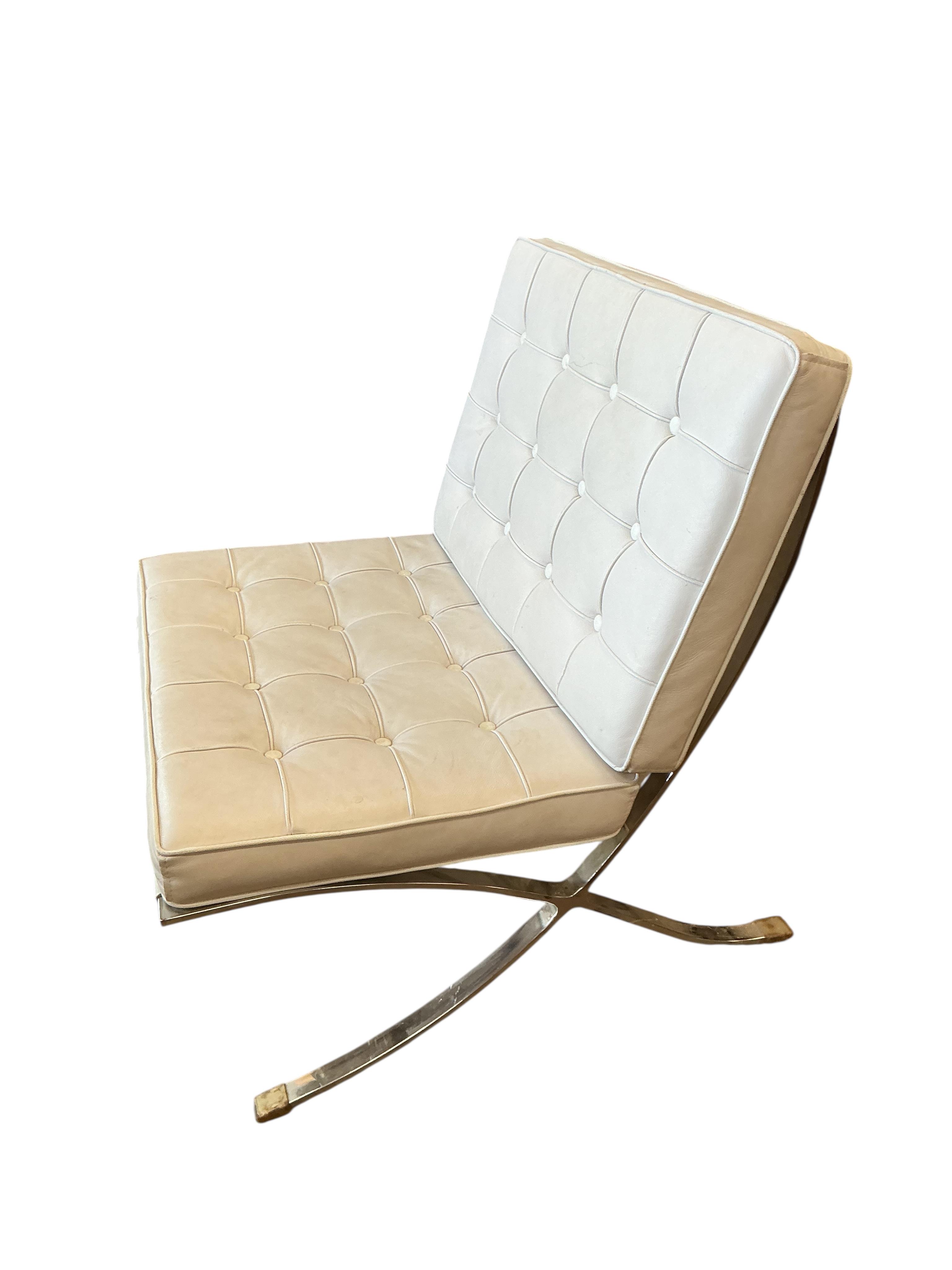 A pair of 'Barcelona' style white leather chairs, width 78cm, depth 80cm, height 82cm and a footstool